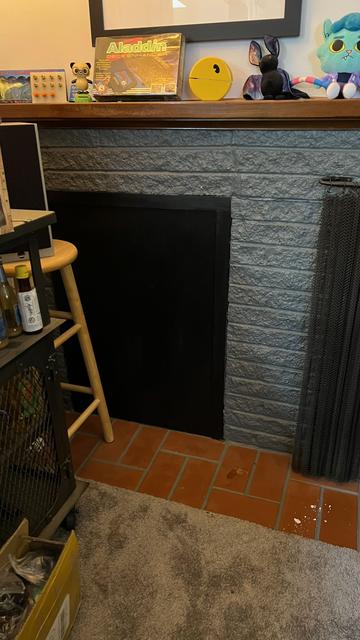 Mysterious black box to the left of a fireplace