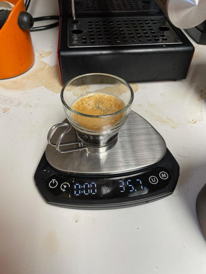 Espresso cup sitting on a scale showing a weight of 35.6g
